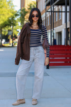 Casual Form Pocket Barrel Leg Jeans in light wash, full length outdoors with a brown jacket