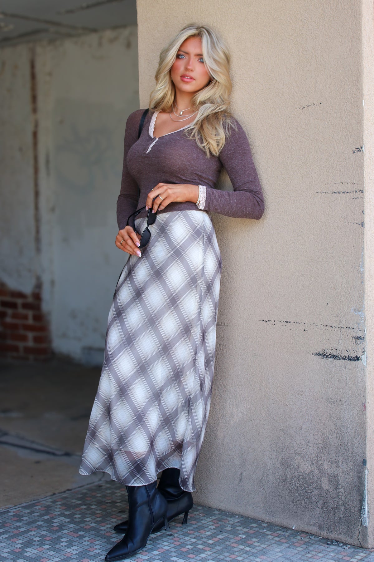 The Tartan Drift Chiffon Plaid Skirt in plaid, full length with a brown top and boots
